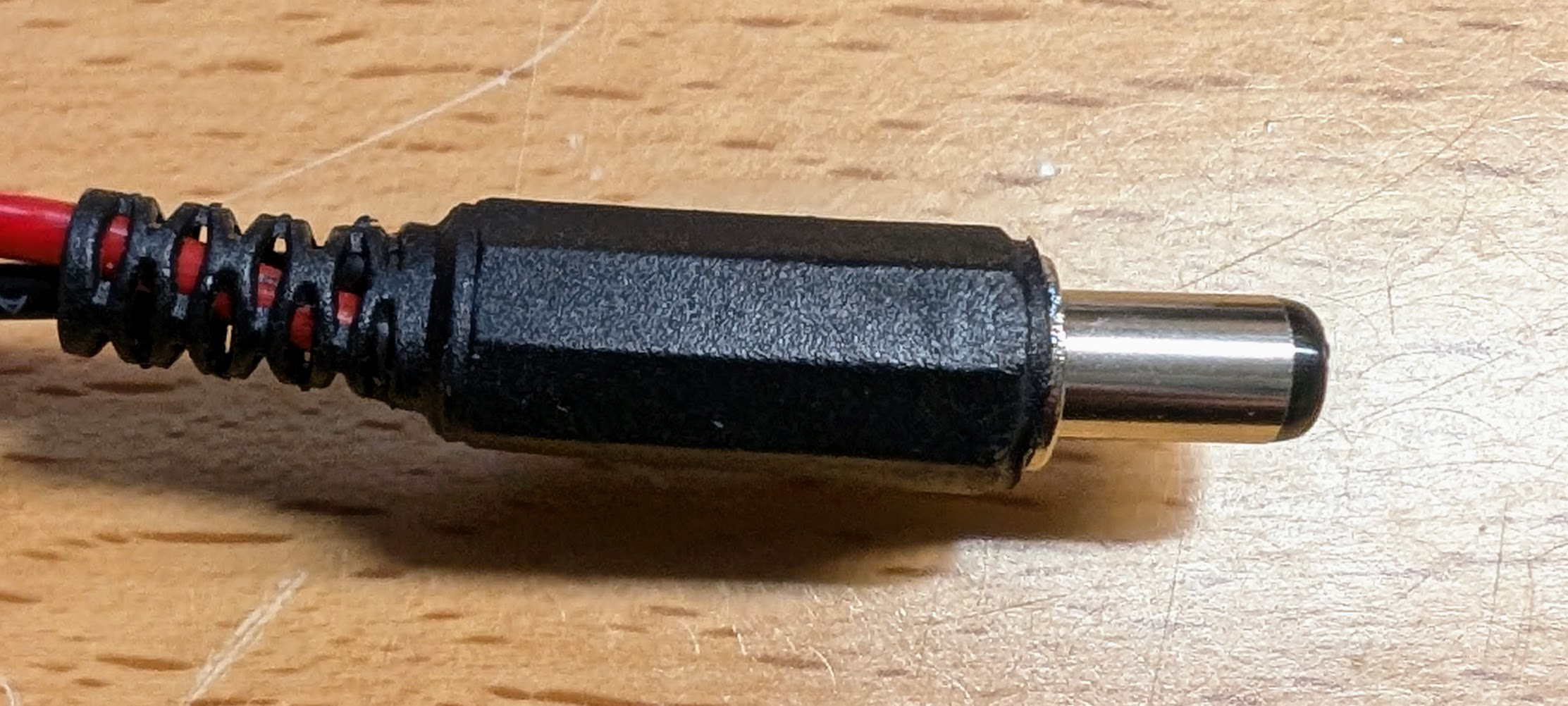 Barrel connector with cover and strain relief