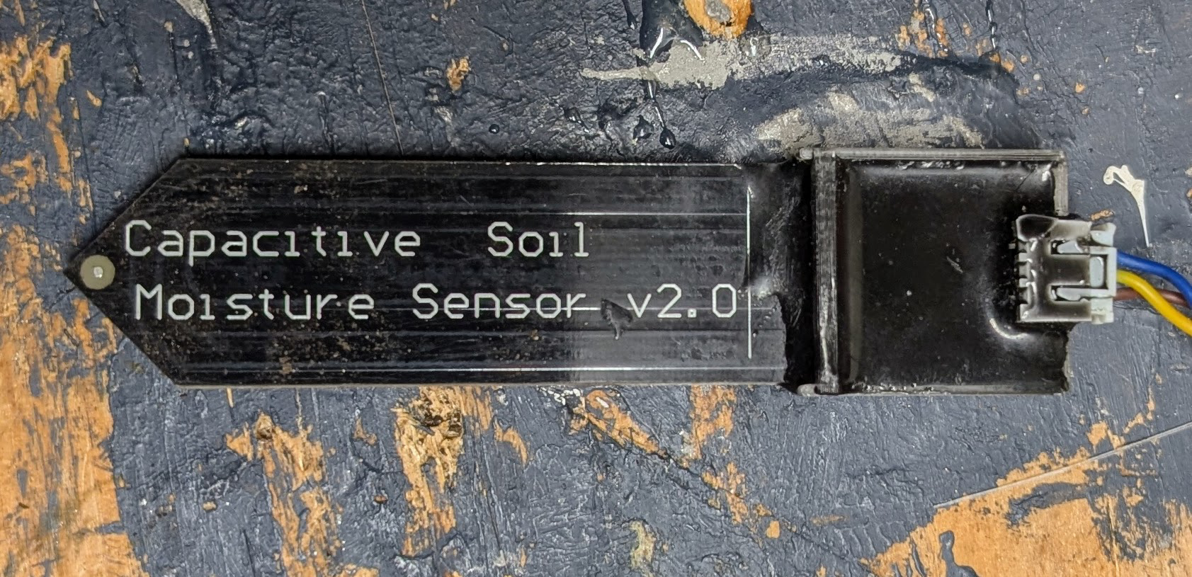 Projecting moisture sensor with potting compound