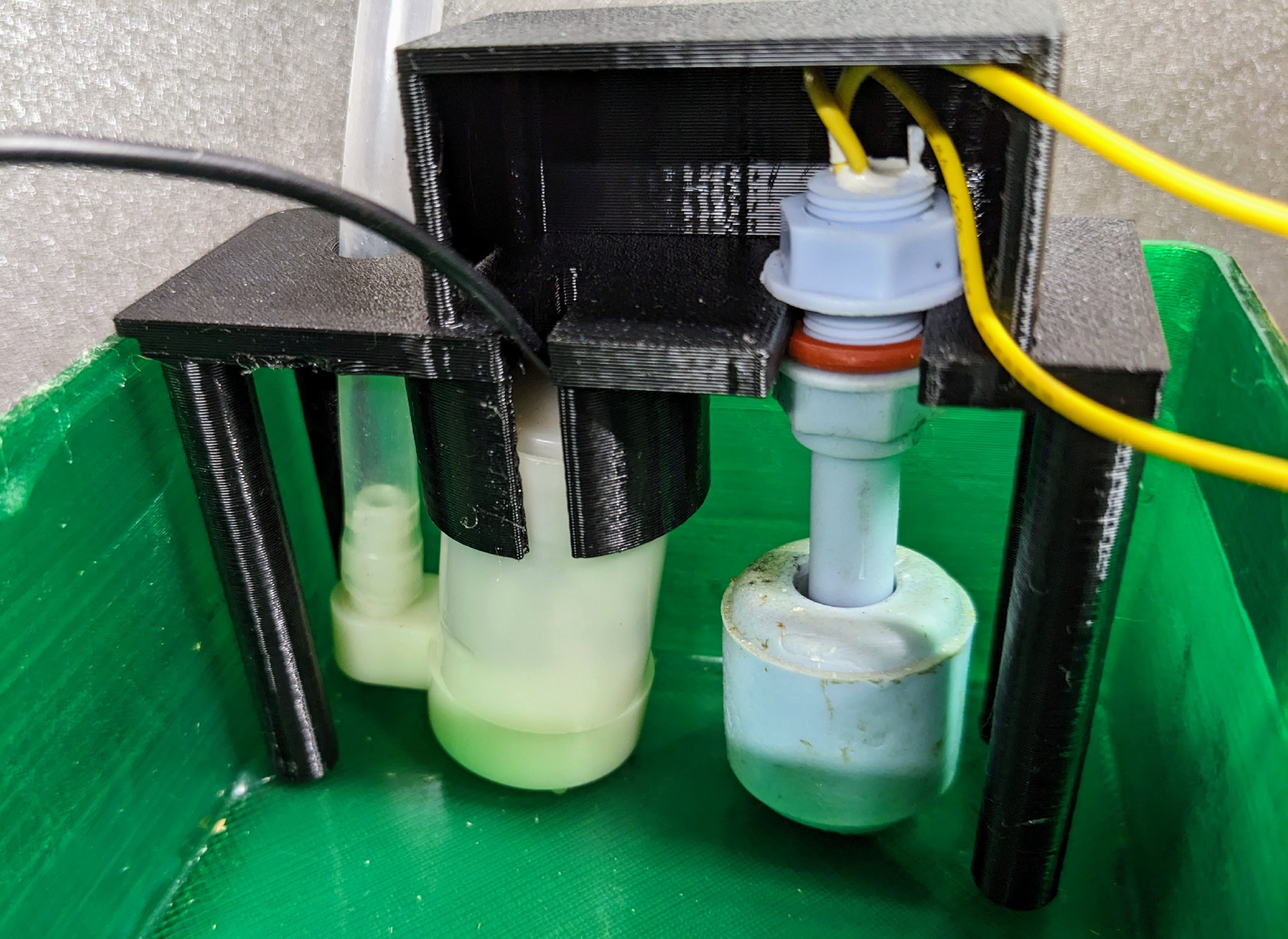 3D printed insert holding the pump and float sensor inside the reservoir