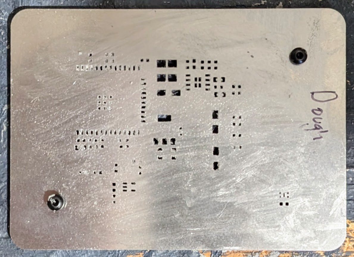 A stencil with screws for holding PCBs in place